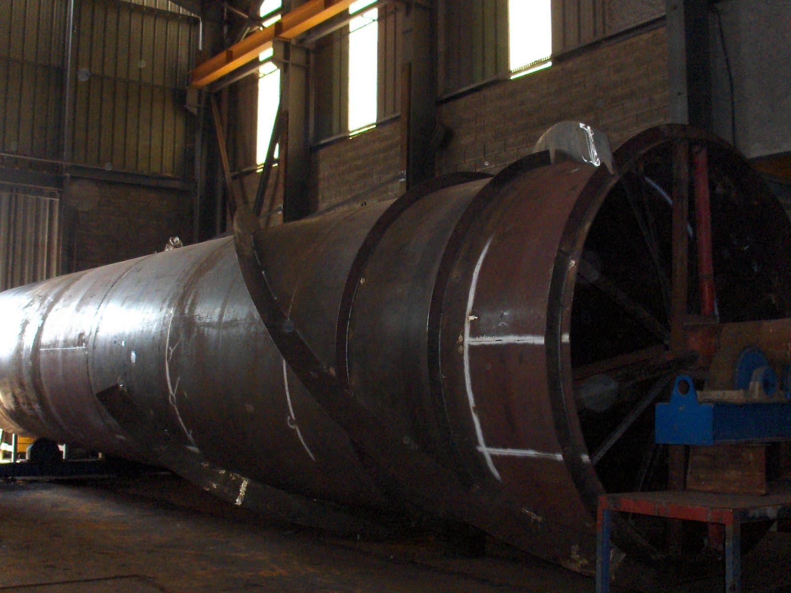 A large-diameter carbon steel duct section under fabrication in the Friginox workshop