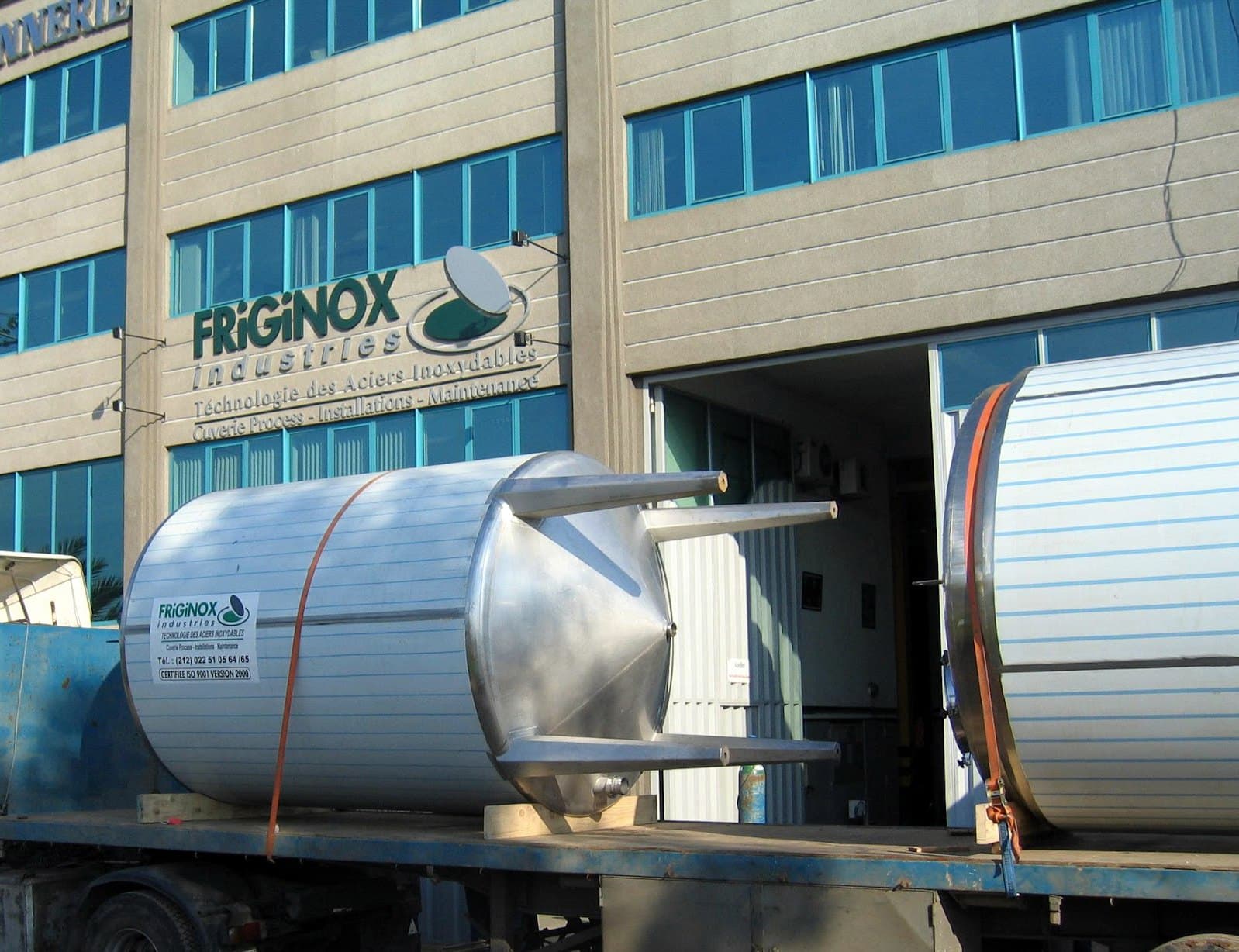 Insulated stainless steel milk tanks loaded on a trailer outside the Friginox plant