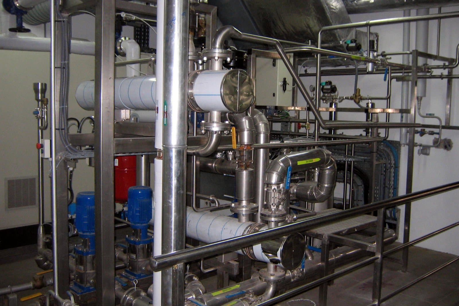 Stainless steel process piping, valves and pumps installed in a clean utility room